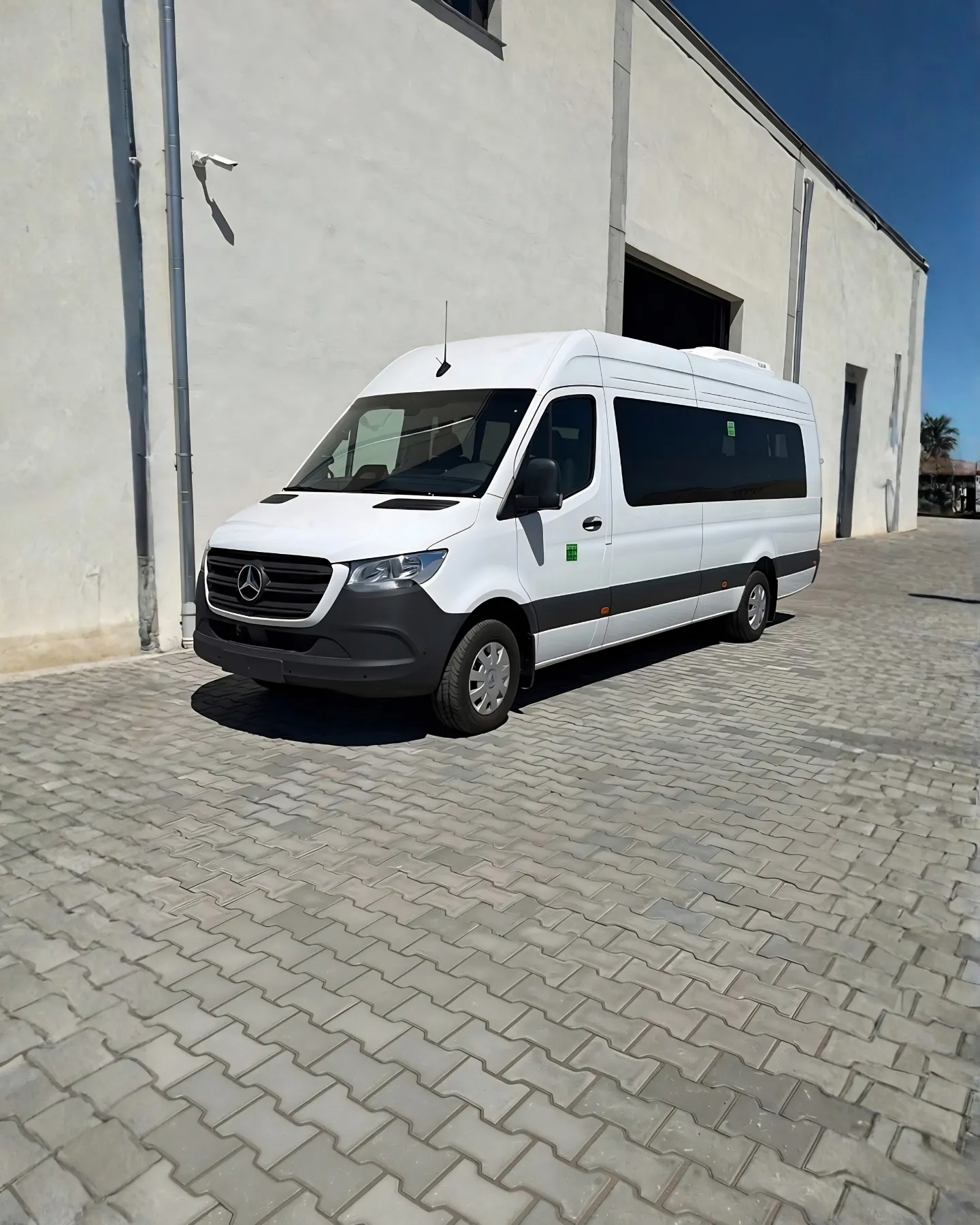 Staff shuttle, white Sprinter shot outdoors